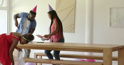 Family Setting Up Decorations for Special Celebration