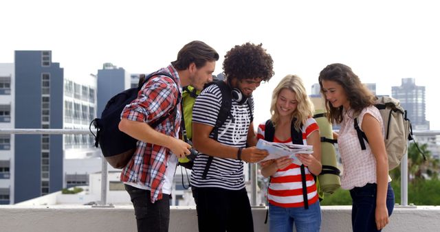 Young Diverse Travelers with Backpacks Exploring City Map Outdoors - Download Free Stock Images Pikwizard.com