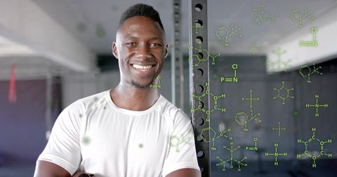 Smiling Athlete in Gym with Scientific Molecular Formulas