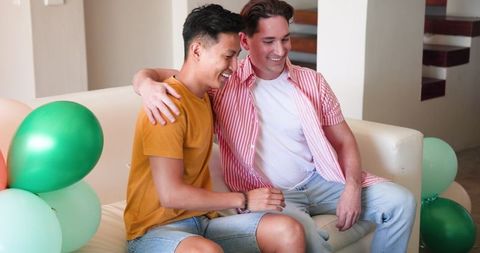 Joyful Friends Decorating Living Room for Birthday Celebration