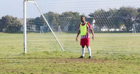 Goalkeeper Training on Sunny Day Focusing Intently on Football Match