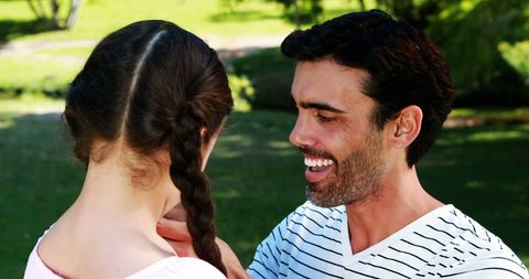 Happy Father Engaging with Daughter in Park