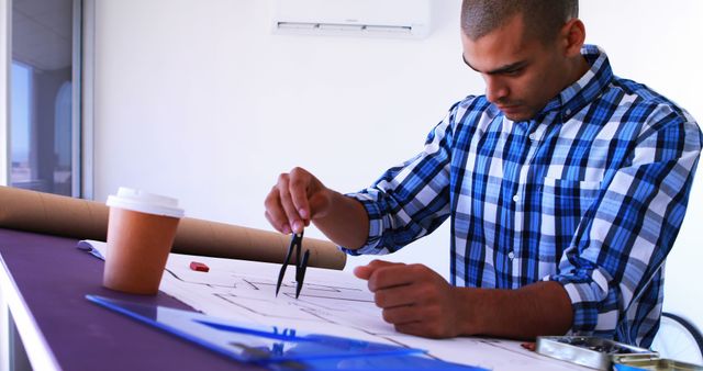 Male Architect Working on Building Plans at Office Desk - Download Free Stock Images Pikwizard.com