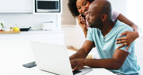 Happy African American Couple Connects Using Laptop in Bright Kitchen - Download Free Stock Images Pikwizard.com