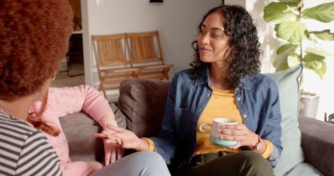 Diverse Women Socializing at Home with Coffee