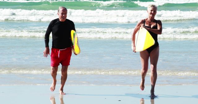 Senior Couple Enjoying Beach Activities with Surfboards - Download Free Stock Images Pikwizard.com