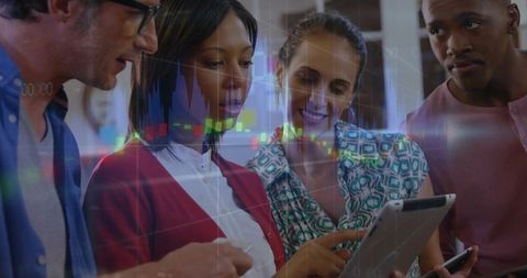 Diverse Team Analyzing Financial Data on Digital Devices in Office