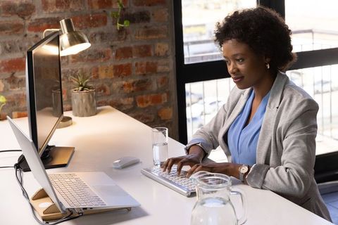 Focused Businesswoman Working at Sleek Modern Office Desk