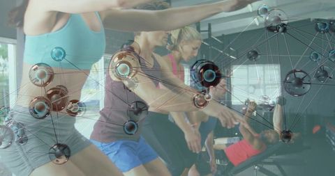 Group performing squats in gym with network overlay conveying fitness technology concept