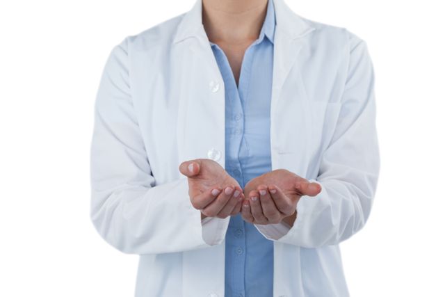 Female doctor wearing a white lab coat and blue shirt, standing with hands cupped against a white background. Useful for medical, healthcare, and professional themes. Ideal for illustrating concepts of support, care, and offering help in medical settings.