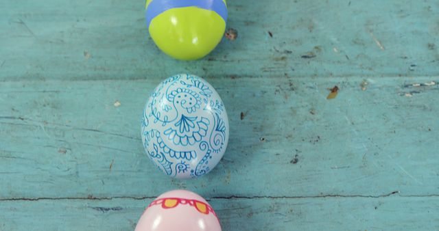 Colorful Easter Eggs Arranged in a Row on Blue Wooden Surface - Download Free Stock Images Pikwizard.com
