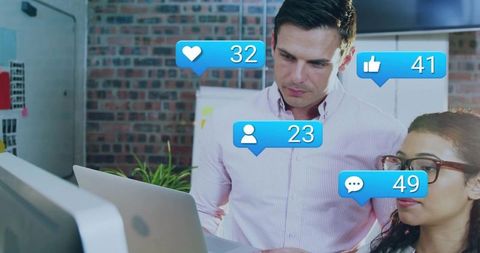 Modern team reviewing social engagement metrics on laptop with social media notifications