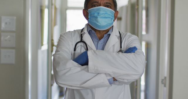 Confident Doctor Wearing Mask and Gloves in Hospital Corridor - Download Free Stock Images Pikwizard.com