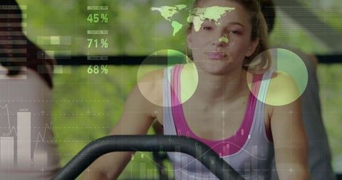 Woman cycling on stationary bike with fitness data overlay for cardio workout analytics