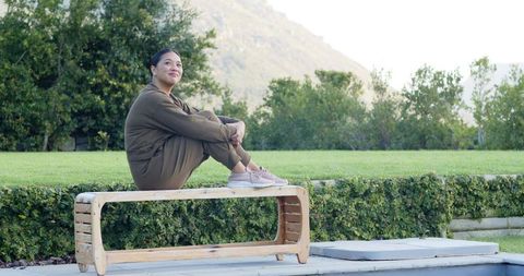 Serene Meditation Outdoors Near Pool in Nature