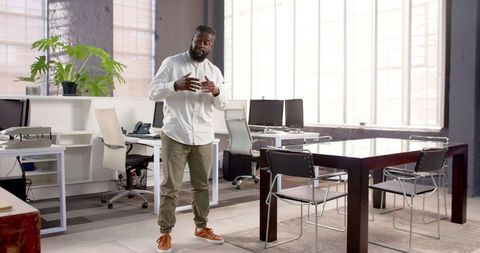 Confident businessman presenting in modern office space