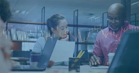 Business professionals collaborating over important documents