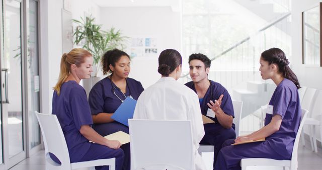 Image of diverse group of male and female doctors sitting in discussion in hospital meeting. Hospital, medical and healthcare services.