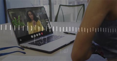 Remote video meeting on laptop with eyeglasses and documents, presenter in mustard top