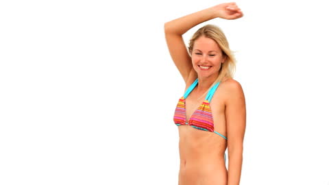 Joyful Woman Enjoying Beach Day with Frisbee in Colorful Bikini