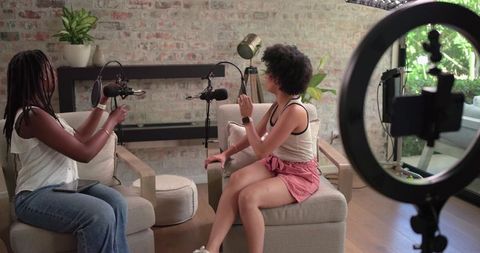 African American creators recording podcast in bright home studio with ring light