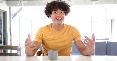 Excited Man Expressing Surprise While Having Morning Coffee