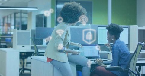 Professionals collaborating in modern office with digital security icons