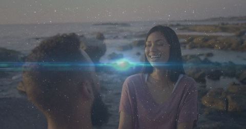 Smiling Couple Enjoys Sunset on Scenic Rocky Shore
