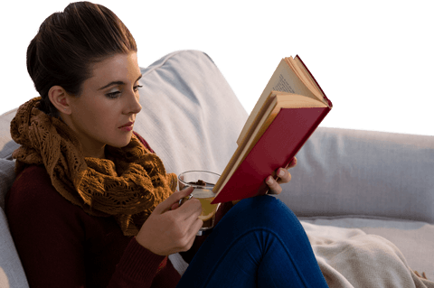 transparent young woman reading with tea on couch - Download Free Stock Videos Pikwizard.com