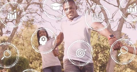 Family walking in sunlit park wearing smartwatch and holding hands with icons overlay