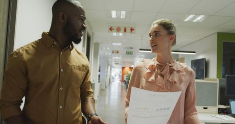 Colleagues Discussing Project in Office Corridor
