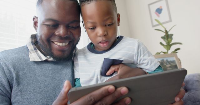 Father and Son Enjoying Tablet Together at Home - Download Free Stock Images Pikwizard.com