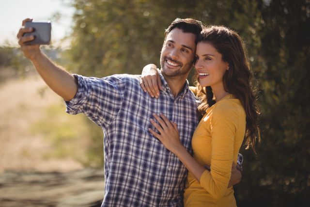 Smiling young couple taking selfie at olive farm - Download Free Stock Photos Pikwizard.com