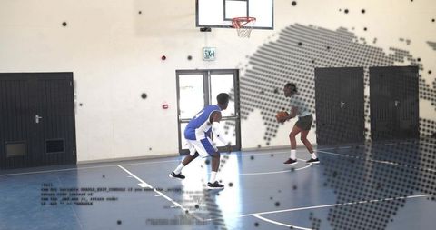 Intense one-on-one defense on indoor basketball court, guarding ballhandler and dribbling