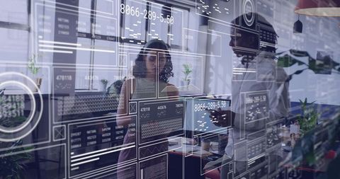 Team collaborating around holographic analytics dashboards in modern open-plan office