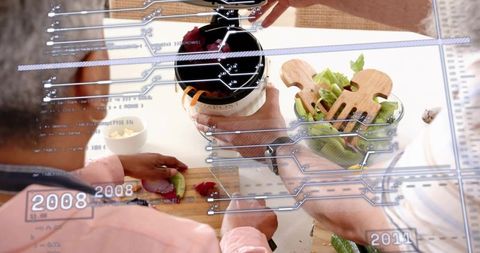 Couple preparing salad with augmented reality hud overlay in modern smart kitchen