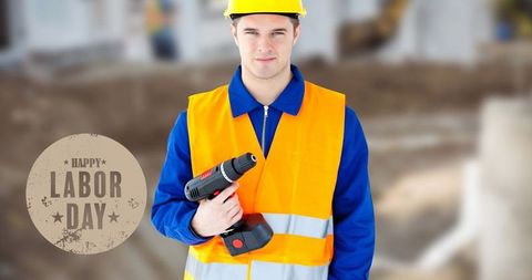 Caucasian construction worker holding drill celebrating labor day
