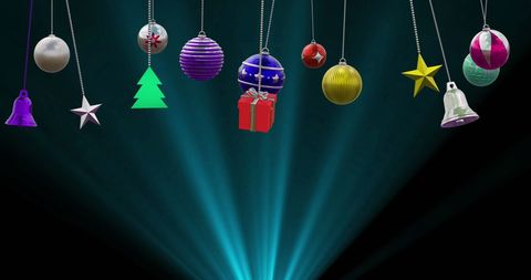 Festive Christmas Baubles Hanging Above Glowing Background
