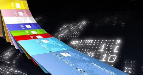Sliding fanned credit cards on neon digital matrix for secure online payments and banking