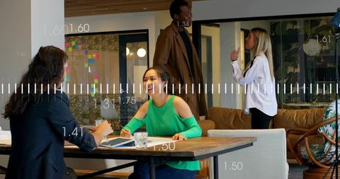 Professional writing and collaborating at coworking table with brainstorming team