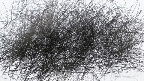 Dynamic abstract ink scribbles on white canvas