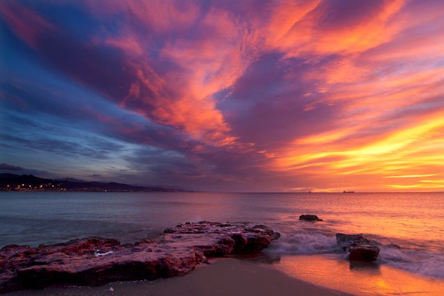 Vibrant Sunset Sky Over Peaceful Ocean and Rocky Shore - Download Free Stock Photos Pikwizard.com