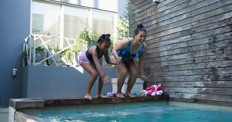 Mother and Daughter Enjoying Playful Pool Time