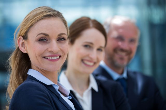 Group of confident business professionals smiling outdoors. Ideal for corporate websites, business presentations, team-building materials, and professional networking profiles.