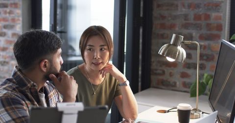 Senior Woman Engaging in Discussion with Young Colleague in Office - Download Free Stock Images Pikwizard.com