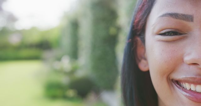 Close-Up of Woman Smiling Outdoors with Green Background - Download Free Stock Images Pikwizard.com