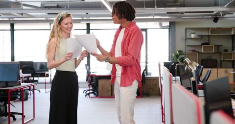 Joyful Colleagues Celebrating Achievement in Modern Office