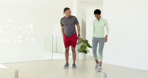 Diverse Friends Exercising Together in Modern Living Room