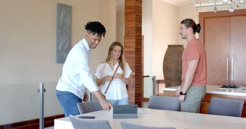Friends Enjoying Together with Tablet in Bright Living Room