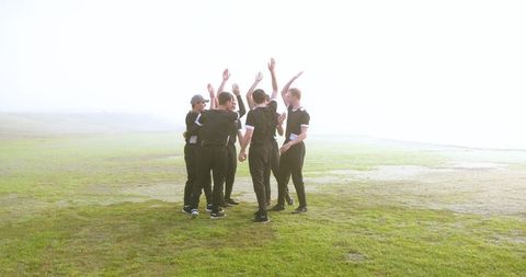 Athletic team unity boost on misty morning field